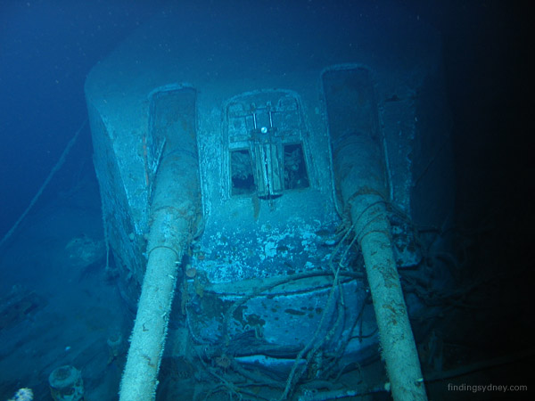 The front of the X turret gun housing on HMAS Sydney, showing shell hits between the barrels.