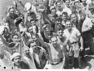 A HAPPY GROUP OF CREW MEMBERS OF HMAS SYDNEY. THE SAILOR IN THE CENTRE OF THE PHOTOGRAPH WITH HIS ARM RAISED IS LEADING STOKER THOMAS NEVIN GLACKIN. (NEGATIVE BY D. PARER)
