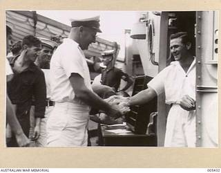 PERTH - H.M.A.S. <em>SYDNEY</em>: AN OFFICER HANDS OUT THE MAIL AFTER IT HAS BEEN SORTED.