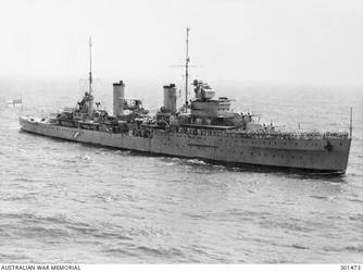1940. AERIAL STARBOARD BOW VIEW OF THE CRUISER HMAS SYDNEY (II) (EX HMS PHAETON). NOTE THE SPAR PROJECTING FORWARD OF THE BRIDGE AND SINGLE 4 INCH AA GUNS AMIDSHIPS, WHICH DISTINGUISHED THE SYDNEY FROM HER TWO SISTERS. HER SEAGULL AMPHIBIAN IS EMBARKED. (NAVAL HISTORICAL COLLECTION)