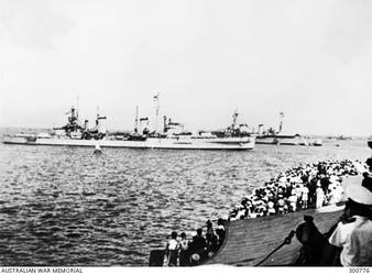 ALEXANDRIA, EGYPT. 1940-07-20. STARBOARD BROADSIDE VIEW OF THE CRUISER HMAS SYDNEY (II1) (EX HMS PHAETON) ENTERING HARBOUR TO THE CHEERS OF THE MEDITERRANEAN FLEET AFTER THE HIGHLY SUCCESSFUL ACTION OFF CAPE SPADA. IN THE LEFT BACKGROUND IS THE FRENCH BATTLESHIP LORRAINE AND, OVER THE SYDNEY'S BOWS, A FRENCH HEAVY CRUISER OF THE TOURVILLE CLASS IS MOORED. BOTH SHIPS WERE INTERNED AFTER THE FALL OF FRANCE A MONTH EARLIER. (NAVAL HISTORICAL COLLECTION)