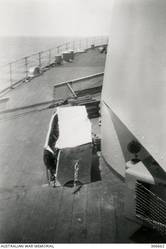 A LOCKER AND VENT BENEATH A TURRET OF THE CRUISER HMAS SYDNEY (II), SHOWING BLAST DAMAGE SUSTAINED DURING THE ACTION WITH THE ITALIAN CRUISER BARTOLOMEO COLLEONI OFF CAPE SPADA. (NAVAL HISTORICAL COLLECTION).