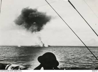 STOPPED AND ON FIRE AFTER THE ACTION OFF CAPE SPADA WITH HMAS SYDNEY (II) THE ITALIAN CRUISER BARTOLOMEO COLLEONI IS HIT BY TWO TORPEDOES AS BRITISH DESTROYERS ADMINISTER THE COUP DE GRACE. HER BOWS HAD BEEN BLOWN OF BY ANOTHER TORPEDO HIT SHORTLY BEFORE. (NAVAL HISTORICAL COLLECTION).