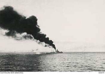 STOPPED AND ON FIRE AFTER THE ACTION OFF CAPE SPADA WITH HMAS SYDNEY (II) THE ITALIAN CRUISER BARTOLOMEO COLLEONI IS HIT BY TWO TORPEDOES AS BRITISH DESTROYERS ADMINISTER THE COUP DE GRACE. HER BOWS HAD BEEN BLOWN OF BY ANOTHER TORPEDO HIT SHORTLY BEFORE. THE SMOKE FROM HER FORE FUNNEL IS CAUSED BY THE HIT TO THE BOILER ROOM THAT STOPPED HER. (NAVAL HISTORICAL COLLECTION).