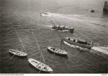 ALEXANDRIA, EGYPT. 1940-07-20. THREE LOCAL CRAFT, KNOWN AS FELUCCAS, AND MOTOR BOATS FOR THE CRUISERS HMS NEPTUNE AND ORION OFF THE PORT SIDE OF THE CRUISER HMAS SYDNEY (II). (NAVAL HISTORICAL COLLECTION).