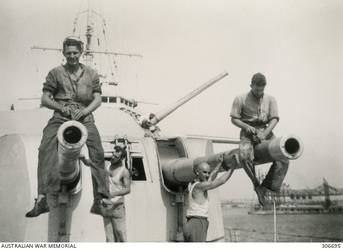 Two sailors sitting on Sydney gun turrets