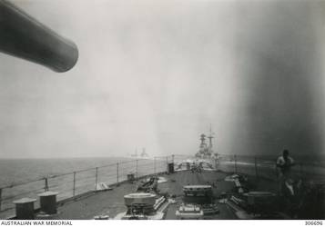Ships of the Mediterranean fleet at sea, seen from the forecastle of the Cruiser HMAS Sydney (II). The next ship ahead is the battleship HMS Royal Sovereign with the aircraft carrier HMS Eagle, two ships further along. The ships are involved in the operations which resulted in action off Calabria against the Italian fleet. (Naval Historical Collection).