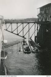 ALEXANDRIA, EGYPT. 1940-07-17. THE FLOATING DOCK BEING PUMPED OUT AS THE CRUISER HMAS SYDNEY (II) IS DOCKED. (NAVAL HISTORICAL COLLECTION).