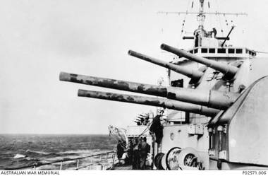 The forward six inch gun turrets of HMAS Sydney II showing the blistered paint on the barrels from the heat of sustained firing at the Italian cruiser Bartolomeo Colleoni during the battle of Cape Sparda, off the coast of Crete. The Italian ship was immobilised by accurate fire from the Sydney's six inch guns and then sunk by torpedo's launched from the escorting British destroyers. Note the Vickers four barreled (quad) .50 calibre, anti aircraft mount in the background.