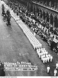 A large crowd of onlookers applaud the ship's company of HMAS Sydney II during a ceremonial welcome home march past the Cenotaph in Martin Place. The march is being lead by Captain John Collins. Later the crew enjoyed a luncheon in Sydney Town Hall. The ship had returned from a successful campaign in the Mediterranean. On 19 November 1941 the Sydney was sunk in the Indian Ocean off the coast of Western Australia by the German auxiliary cruiser Kormoran. All 645 personnel on board HMAS Sydney were lost.