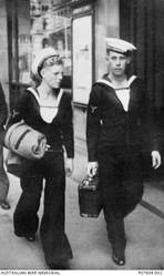 Informal street portrait, probably taken in Sydney, NSW, of 25906 Stoker Second Class (Sto II) Keith William Trenbath (right), of Wickham, NSW, and an unidentified Australian sailor. Sto II Trenbath originally enlisted as a gunner in the Australian Army on 27 May 1939, serving in 1 Field Regiment, Royal Australian Artillery. On 20 November 1941 Gunner (Gnr) Trenbath's brother, Stoker Third Class (Sto III) Jack Stephen Trenbath, was killed in action, aged 17, when HMAS Sydney II was sunk by the German auxiliary cruiser Kormoran. Gnr Trenbath transferred to the RAN in January 1942. He was killed in action, aged 21, when the ship on which he was serving, HMAS Armidale, was attacked and sunk by Japanese aircraft, north west of Darwin, on 1 December 1942. Sto II Keith Trenbath was reported missing presumed dead 8 December 1942.