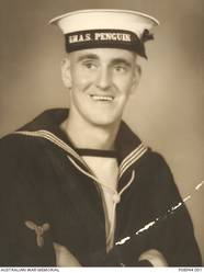 Studio portrait of S4546 Stoker Class II (Sto II) Donald Walter Chilcott, HMAS Penguin. A metal polisher on enlistment in the Royal Australian Naval Reserve on 9 September 1940, Sto II Chilcott was initially posted to HMAS Rushcutter before tansferring to HMAS Cerberus. After serving on HMAS Penguin, HMAS Burnie and HMAS Toowoomba and following promotions to Stoker and Acting Leading Stoker, Chilcott transferred to HMAS Adelaide on 31 October 1941. At the time HMAS Adelaide was based in Fremantle for convoy and escort duties. On 28 November 1941, during an escort to the Southern Indian Ocean the Adelaide sank the German blockade runner Ramses. On 26 July 1943 Chilcott transferred to HMAS Bendigo and later in the year was confirmed as Leading Stoker. HMAS Bendigo commenced escort and patrol duties in the New Guinea area in February 1943 and in March 1945 became part of a Task Unit operating with the British Pacific Fleet in Philippine waters. Chilcott was later rated Stoker Petty Officer and transferred to HMAS Cowra then HMAS Rushcutter before his discharge on 9 April 1946.