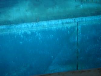 Ship's port side in vicinity of gun deck. Camouflage paint visible