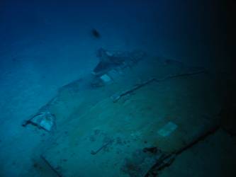 What appears to be a brick lying on piece of steel wreckage