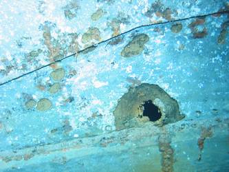 Shell hit above boot topping on stbd side below 4-inch gun deck