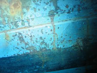 Shell hit above boot topping on stbd side below 4-inch gun deck