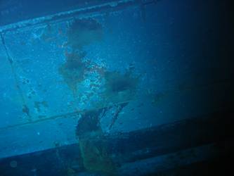 Shell hits on ships stbd side below  torpedo tube mount