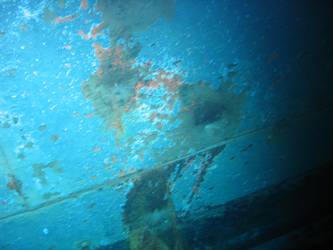 Shell hits on ships stbd side below  torpedo tube mount