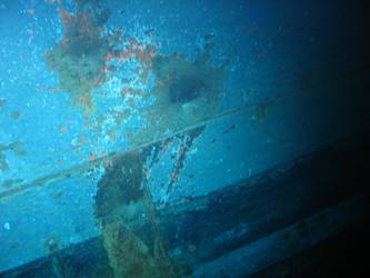 Shell hits on ships stbd side below  torpedo tube mount