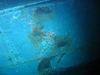 Shell hits on ships stbd side below  torpedo tube mount