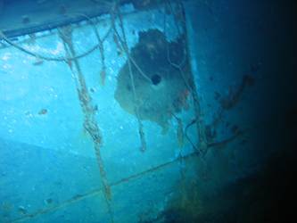 Shell hole immediately below stbd aft 27 whaler cradle
