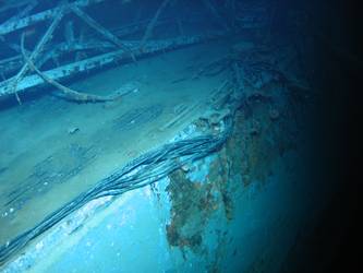 Aircraft crane slew lying on deck stbd side, degaussing wire visible