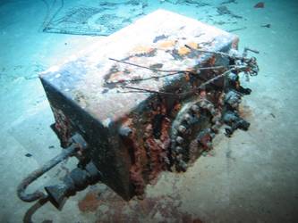 Rectangular box with piping and inspection cover on seabed