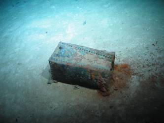 Rectangular riveted steel box on seabed