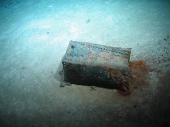 Rectangular riveted steel box on seabed