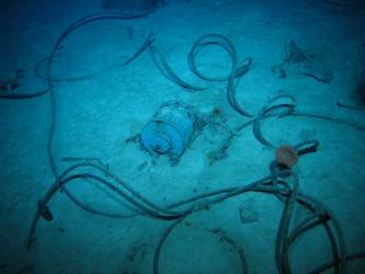 Steel wire rope on seabed near cylindrical drum