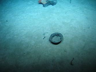 British patent steel helmet upside down on seabed